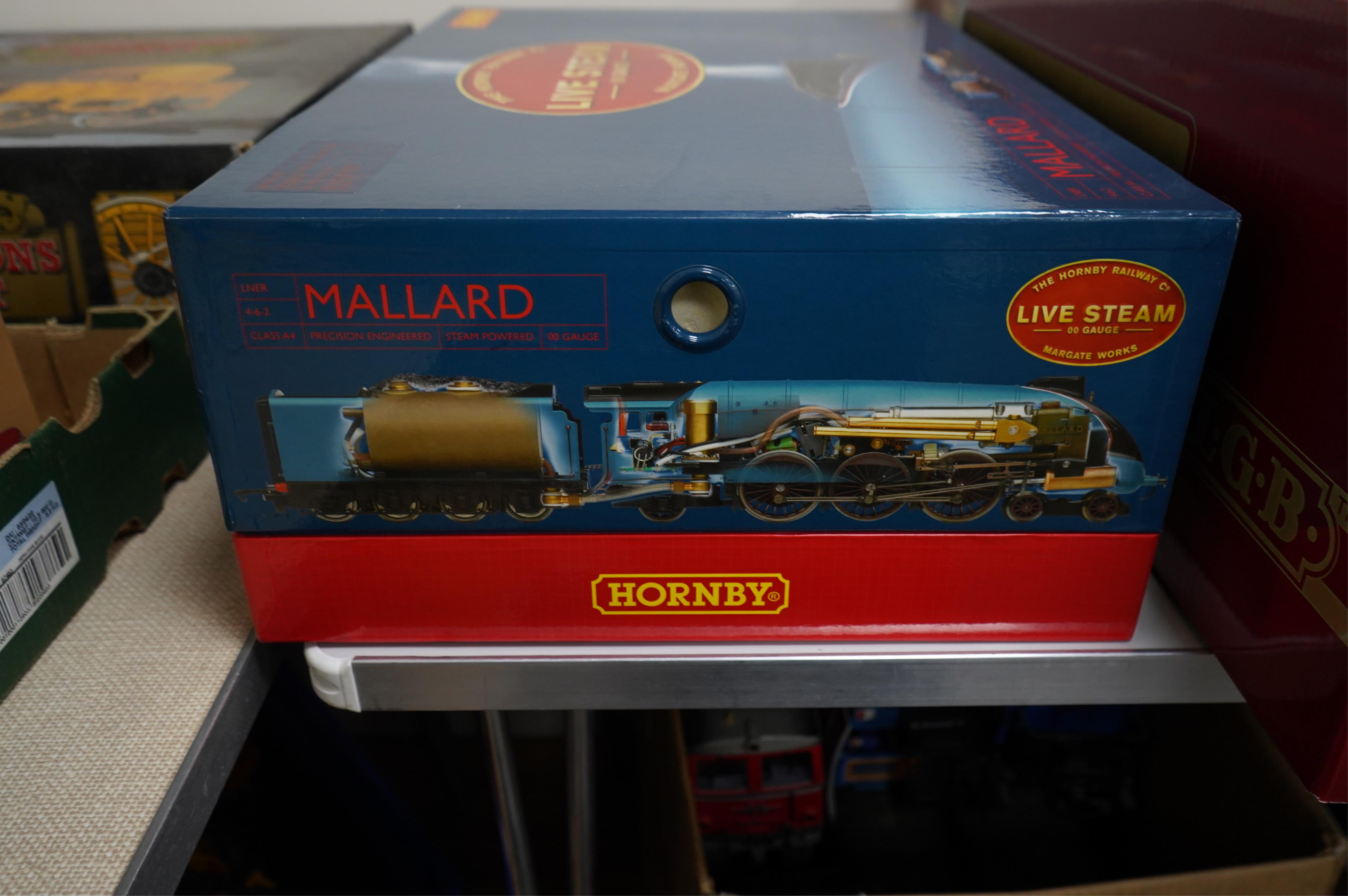 A boxed Hornby Hobbies 00 gauge railway live steam train set, comprising of an LNER Class A4 locomotive, Mallard, a quantity of track sections, controllers, and other accessories. Condition - good, appears unused with in